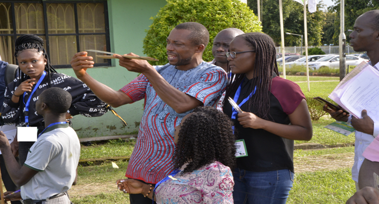 Prof. Odo demonstrating to participants, an open field experiment on how astronomers measure distances to astronomical objects